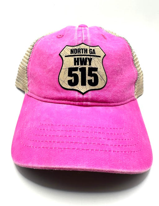 A pink pony tail hat with 'NORTH GA HWY 515' printed on the front.